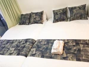 two beds in a room with a bag on them at Roppongi ClassyHouse902 in Tokyo