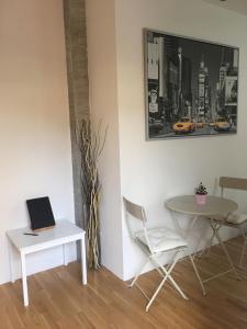 a room with a table and a laptop on a table at Lulù in Impruneta
