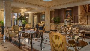 a lobby with a table and chairs in a building at Relais & Châteaux Hotel Orfila in Madrid
