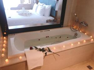 A bathroom at Maximilan Danang Beach Hotel