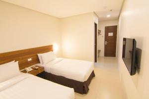Mango Suites Cauayan客房内的一张或多张床位
