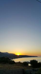 a sunset over a body of water at Porto Kastri Studios in Kastrí