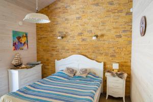 a bedroom with a bed and a brick wall at Villa Hausma in Hiiumaa