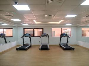 a gym with three treadmills in a room at Frank Porter - Elite Sports Residence in Dubai