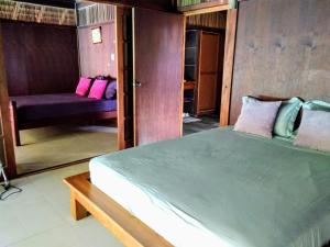 a bedroom with a large bed and a couch at Pool Mountain Moorea in Moorea