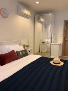a bedroom with a bed with a hat on it at Rain Chaam Huahin by Joe in Phetchaburi