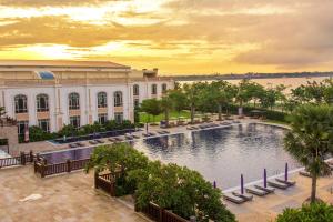 an exterior view of a building with a swimming pool at Sokha Phnom Penh Hotel in Phnom Penh