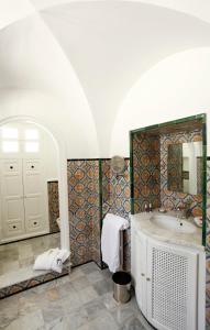 a bathroom with a tub and a sink at La Villa Bleue-Sidi Bou Said in Sidi Bou Saïd
