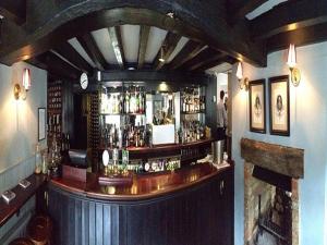 a bar in a pub with a wooden counter at The Black Horse Fulmer in Fulmer +8 photos