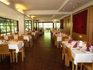 a restaurant with tables and chairs with purple napkins at Schloss Puchberg in Wels