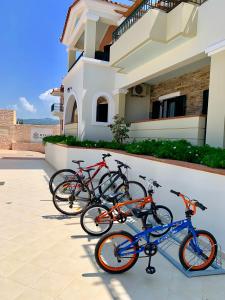 tre biciclette parcheggiate di fronte a una casa di Messina Resort Hotel a Kyparissia