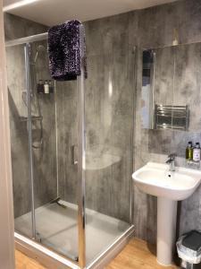 a bathroom with a shower and a sink at The Granary, Wolds Way Holiday Cottages, spacious 3 bed cottage in Cottingham