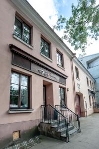 a pink building with stairs in front of it at Pogo Hostel in Vilnius