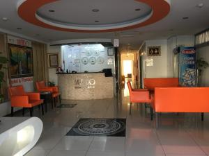 a restaurant with orange chairs and a bar in a room at Mutado Hotel in Antalya