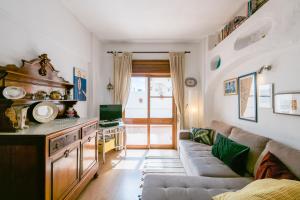 a living room with a couch and a table at Sons do Mar - Charming Apartment by the Sea in Armação de Pêra