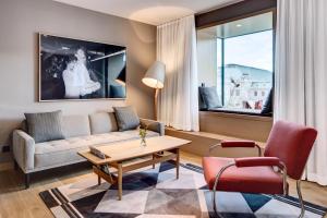a living room with a couch and a table and chairs at The Guesthouse Vienna in Vienna
