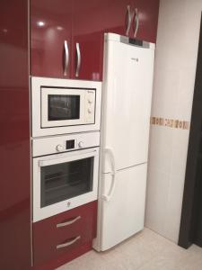 a white oven and a refrigerator in a kitchen at Apart. con encanto en Torremolinos (Joaquin Blake) in Torremolinos