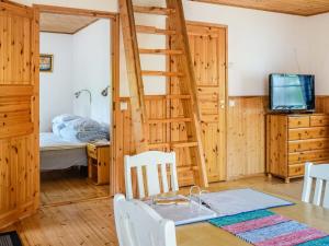 a room with a dining table and a bunk bed at Holiday Home Naurulokki 4 by Interhome in Strandby