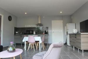 a kitchen and living room with a table and chairs at appartement coubillou in Lamalou-les-Bains