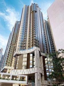 wysoki budynek z wieloma oknami w mieście w obiekcie Hotel Alexandra w Hongkongu