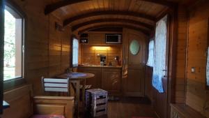 a small kitchen with a sink in a room at Les roulottes Vesta in Léognan +59 photos