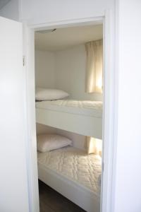 a closet with two bunk beds in it at Chalet Charlee in IJmuiden