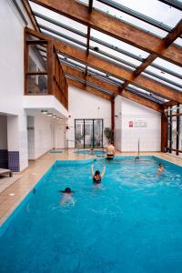 a group of people swimming in a swimming pool at The Hannafore Point Hotel in Looe