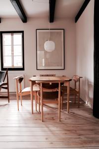 een eetkamer met een houten tafel en stoelen bij House of Finn Juhl Hakuba in Hakuba