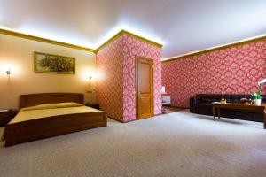 a large bedroom with a bed and a couch at Apart Hotel Clumba in Odesa