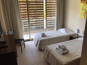 a hotel room with two beds and a window at Salgados Beach in Albufeira +40 photos