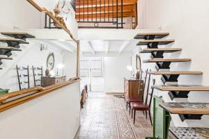 a tasting room with tables and chairs in a building at Palazzo dei Normanni Stylish Apartment in Palermo