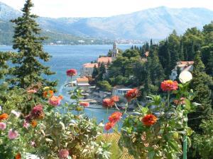 a view of a town and a lake with flowers at Apartment Lucija in Korčula