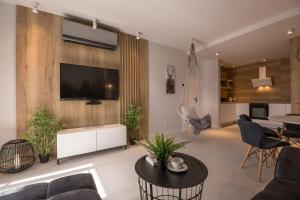 a living room with a flat screen tv on a wall at Apartamenty Rynek w samym centrum Ustronia - Dream Apart in Ustroń
