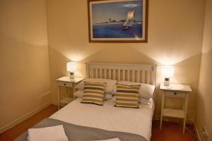 a bedroom with a bed with two lamps on two tables at The Old Pickle House in Kelso