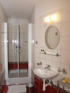 a bathroom with a shower and a sink at Hotel U Zlatého Lva in Havlickuv Brod