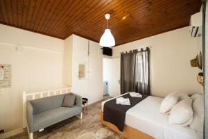 - une chambre avec un lit et une chaise dans l'établissement LEFKADA CENTRAL SQUARE APARTMENT, à Leucade