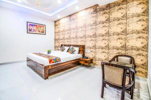 1 dormitorio con 1 cama y pared de madera en FabHotel Elysian Grand Lucknow Airport en Lucknow