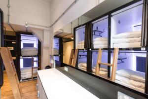 a room with three bunk beds in a room with windows at CoDE Pod – The CoURT - Edinburgh in Edinburgh