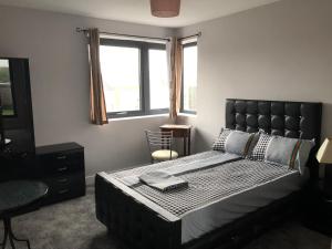 a bedroom with a large bed and a window at Central Unite management Ltd in Manchester
