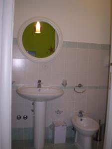 a bathroom with a sink and a toilet at Porto di Mare in Praia a Mare