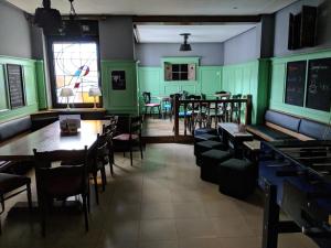 a restaurant with green walls and tables and chairs at Ruhrtropolis Hostel in Essen