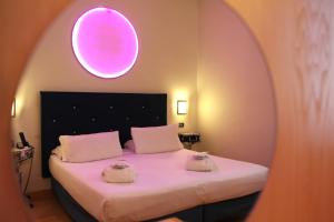a bedroom with a bed with two towels on it at Hotel Franklin Feel The Sound in Rome