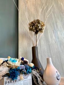 a vase with flowers in it sitting on a table at Tian Zhong Hotel in Tianzhong