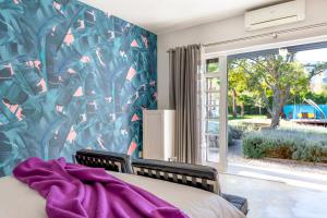 a bedroom with a bed and a large window at Bloomestate Swellendam in Swellendam +50 photos