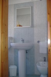 a bathroom with a sink and a toilet at Hotel Pensione Signorini in Castiglioncello