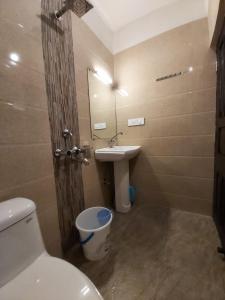a bathroom with a toilet and a sink at Marigold Manor Homestay in Darjeeling
