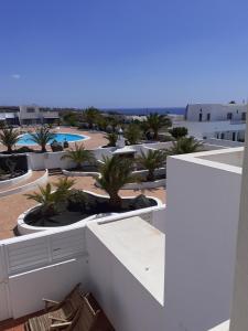 uitzicht vanaf het balkon van een resort met palmbomen bij Casa Mi Sol in Puerto Calero