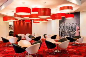 a waiting room with chairs and red carpet at Park Inn by Radisson Palace in Southend-on-Sea