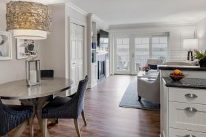 
a kitchen with a table and chairs and a refrigerator at Wentworth by the Sea, A Marriott Hotel & Spa in New Castle
