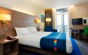 a hotel room with a large bed and a television at Park Inn by Radisson Palace in Southend-on-Sea